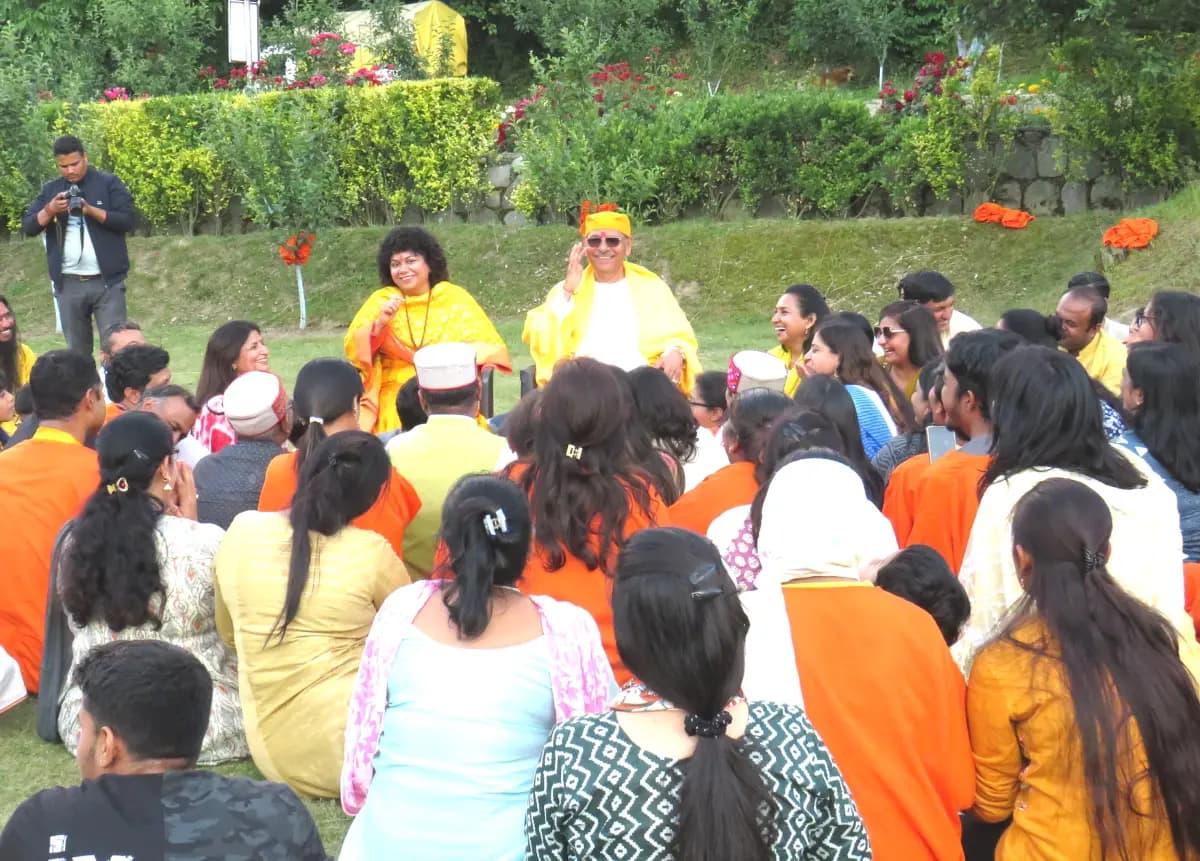A group of people in a Q & A session with a speaker in yellow attire